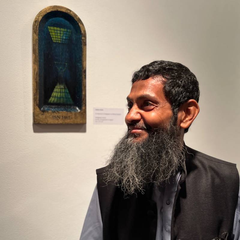 Ahmed Rabbani at the opening of ‘The Unforgotten Moon’ in front of ‘Strappado’ a painting by Amra Khan