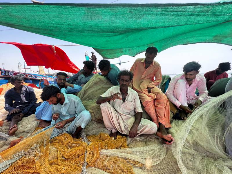Still from the film (work in progress) *Hoora* (working title), seen in the image are a group of fishermen repairing fishing nets at the Ibrahim Hyderi, 2021