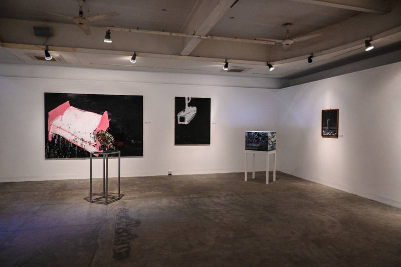 Installation view from ‘The Unforgotten Moon’ exhibited at the Indus Valley Gallery, Karachi, Pakistan. (Left to right) Ahmed Rabbani’s painting palette, alongside works by Abdullah Quereshi, Faraz Amer Khan, and Natasha Malik