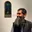 Ahmed Rabbani at the opening of ‘The Unforgotten Moon’ in front of ‘Strappado’ a painting by Amra Khan