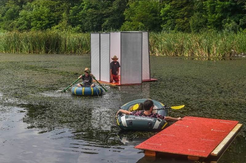 Founders of E T A J artist-run space, Mircea and Dumitru, setting up the OFFSHORE WHITE CUBE exhibition on the lake, August 2020