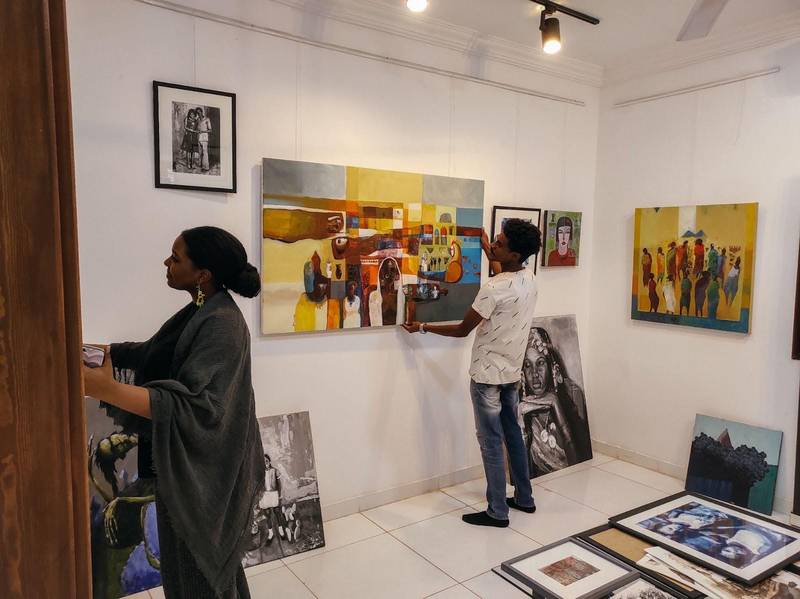 Young gallery interns help to hang the art. *Downtown Gallery* in Khartoum, 2022\. Photo: Rahiem Shadad