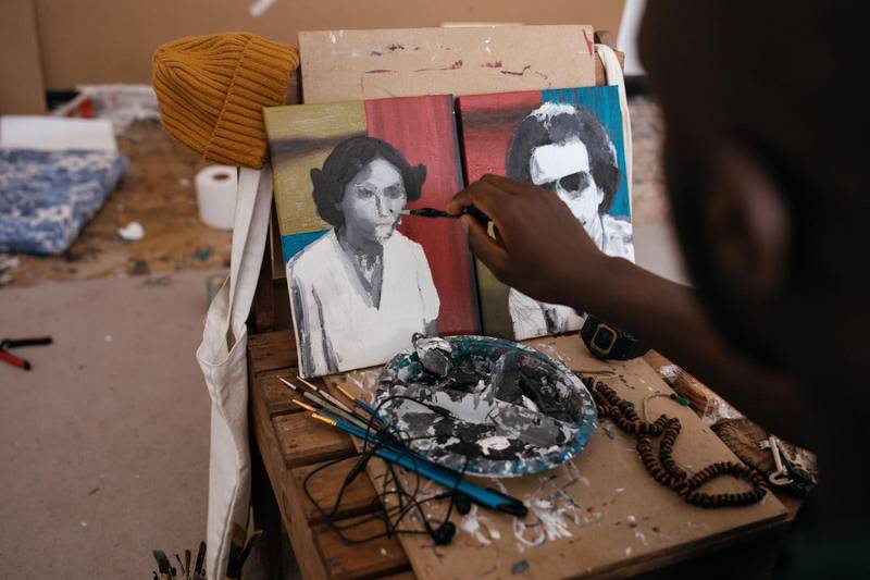 Waleed Mohammed painting from his bed