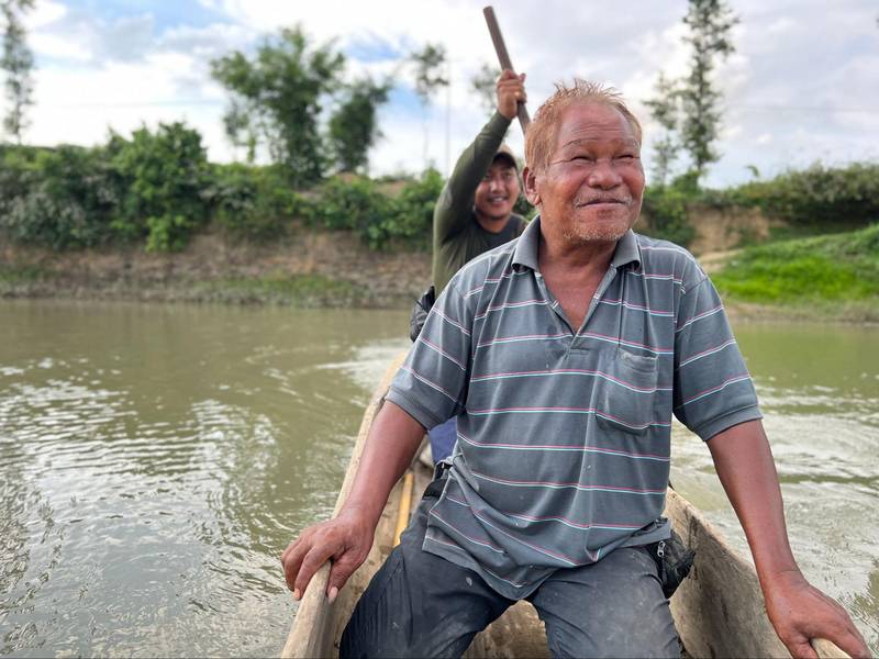 Hemkholen Touthang lets a passenger take the ropes as they cross the Manipur River